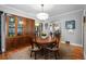 Traditional dining room boasts hardwood floors, a wooden table, and a classic china cabinet at 1429 Hudson St, Denver, CO 80220