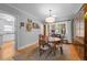 Inviting dining room with hardwood floors, a round table, and vintage light fixture at 1429 Hudson St, Denver, CO 80220