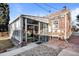 Backyard exterior of a home with a sunroom and brick siding at 1429 Hudson St, Denver, CO 80220