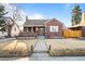 Charming brick home features a covered porch, landscaped front yard and sidewalk to street at 1429 Hudson St, Denver, CO 80220