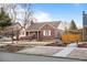 Well-maintained brick home with tidy landscaping, a covered porch and a cozy, inviting facade at 1429 Hudson St, Denver, CO 80220