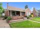 Charming brick bungalow featuring a covered front porch, offering a welcoming entrance and outdoor living space at 1429 Hudson St, Denver, CO 80220
