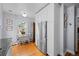 Eat-in kitchen with white cabinets, stainless steel appliances, and hardwood floors at 1429 Hudson St, Denver, CO 80220