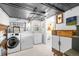 Functional laundry room with modern washer and dryer, and a stylish sink at 1429 Hudson St, Denver, CO 80220