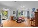 Spacious living room with hardwood floors, large windows, and an arched doorway leading to other living spaces at 1429 Hudson St, Denver, CO 80220