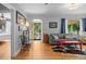 Bright living room featuring gleaming hardwood floors and an arched doorway, creating an open and airy atmosphere at 1429 Hudson St, Denver, CO 80220