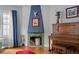 Living room featuring a decorative fireplace, wood floors, and unique artwork at 1429 Hudson St, Denver, CO 80220