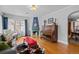Open-concept living room featuring a decorative fireplace, hardwood floors, and an adjacent dining area at 1429 Hudson St, Denver, CO 80220
