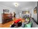 Spacious living room featuring hardwood floors, cozy seating, and a vintage piano at 1429 Hudson St, Denver, CO 80220