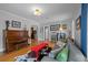 Spacious living room featuring hardwood floors, comfortable seating, and an upright piano at 1429 Hudson St, Denver, CO 80220