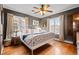 Spacious main bedroom with hardwood floors, ceiling fan, large windows, and decorative accents at 1429 Hudson St, Denver, CO 80220