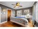 Cozy main bedroom with hardwood floors, ceiling fan, large windows, and decorative accents at 1429 Hudson St, Denver, CO 80220