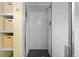 Updated shower with white subway tile and black mosaic floor tiles at 1429 Hudson St, Denver, CO 80220