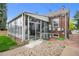 Enclosed back porch/sunroom with many windows providing natural light and exterior access to the backyard at 1429 Hudson St, Denver, CO 80220