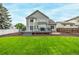 Expansive backyard features a deck, lush lawn, and mature landscaping, perfect for outdoor living at 20710 E Princeton Pl, Aurora, CO 80013