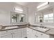 Well-lit bathroom with dual sinks, quartz countertops, and sleek cabinetry at 20710 E Princeton Pl, Aurora, CO 80013