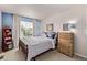 Bright bedroom featuring a wooden bed, blue accent wall, and abundant natural light at 20710 E Princeton Pl, Aurora, CO 80013