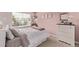 Cozy bedroom with soft pink walls, dresser, and window, creating a relaxing atmosphere at 20710 E Princeton Pl, Aurora, CO 80013