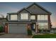 Charming two-story home showcasing gray siding, brick accents, and well-maintained landscaping at 20710 E Princeton Pl, Aurora, CO 80013