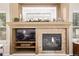 Close-up of the fireplace with decorative mantel, stone surround, and built-in media storage at 20710 E Princeton Pl, Aurora, CO 80013