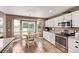Eat-in kitchen features stainless steel appliances, granite counters, white cabinets, and sunny breakfast nook at 20710 E Princeton Pl, Aurora, CO 80013