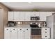 Well-lit kitchen features stainless steel appliances, granite countertops, and white cabinets at 20710 E Princeton Pl, Aurora, CO 80013