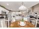 Open kitchen and breakfast nook lead into a cozy living room with a fireplace and staircase at 20710 E Princeton Pl, Aurora, CO 80013