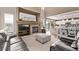 Inviting living room with fireplace, stone surround, and open floor plan to kitchen and breakfast nook at 20710 E Princeton Pl, Aurora, CO 80013