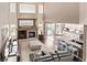 Open-concept living room with a fireplace, hardwood floors, and modern kitchen access at 20710 E Princeton Pl, Aurora, CO 80013