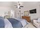 Bright main bedroom features an ensuite bathroom, ceiling fan, and large windows at 20710 E Princeton Pl, Aurora, CO 80013
