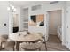 Cozy dining room with a round table, stylish chairs, modern lighting, and convenient laundry access at 485 Interlocken Blvd # 201, Broomfield, CO 80021