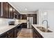 Kitchen featuring white countertops, stainless appliances, and dark cabinets at 485 Interlocken Blvd # 201, Broomfield, CO 80021