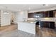 Kitchen with island, white countertops, stainless appliances, and a laundry room at 485 Interlocken Blvd # 201, Broomfield, CO 80021