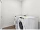 Bright laundry room with stacked washer and dryer at 485 Interlocken Blvd # 201, Broomfield, CO 80021