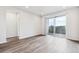 Bright living room features sliding glass doors to balcony and wood-look flooring at 485 Interlocken Blvd # 201, Broomfield, CO 80021