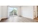 Living room featuring sliding glass doors to a balcony and wood-look flooring at 485 Interlocken Blvd # 201, Broomfield, CO 80021