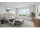 Serene main bedroom with a large window, decorative mirror, and contemporary furnishings at 485 Interlocken Blvd # 201, Broomfield, CO 80021
