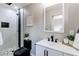 This bathroom features a floating vanity and a modern shower with black trim and stone tile flooring at 9141 Gail Ct, Thornton, CO 80229