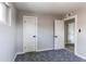 This room features neutral walls and carpet and two white doors at 9141 Gail Ct, Thornton, CO 80229