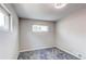 This bedroom features neutral walls, carpet, base molding, and windows at 9141 Gail Ct, Thornton, CO 80229