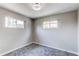 This bedroom has neutral walls, carpet, base molding, and windows at 9141 Gail Ct, Thornton, CO 80229