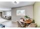 Cozy dining area features a classic wood table with plush chairs and an adjacent bright living room space at 9141 Gail Ct, Thornton, CO 80229