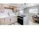 Modern kitchen boasts stainless steel appliances, gray cabinetry, a sleek stovetop, and an adjacent dining space at 9141 Gail Ct, Thornton, CO 80229