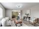 Inviting living room with stylish furniture, light gray walls, and seamless open-concept design leading to dining area at 9141 Gail Ct, Thornton, CO 80229