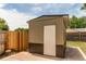 Exterior view of shed with a white door, concrete foundation and wood fencing at 9141 Gail Ct, Thornton, CO 80229