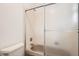 Cozy bathroom featuring a shower-tub combo with sliding door and fixtures, next to the toilet at 1800 Centaur Village Dr, Lafayette, CO 80026