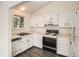 Bright kitchen featuring white cabinets, modern appliances, and durable vinyl flooring at 1800 Centaur Village Dr, Lafayette, CO 80026