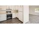 Well-lit kitchen with classic white cabinetry, and modern appliances at 1800 Centaur Village Dr, Lafayette, CO 80026