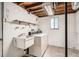 View of the laundry room featuring a washing machine, dryer, sink, and shelving at 1800 Centaur Village Dr, Lafayette, CO 80026