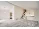Spacious living room with vaulted ceilings, plush carpeting, and a view into the kitchen at 1800 Centaur Village Dr, Lafayette, CO 80026
